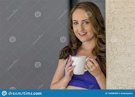 lovely brunette model enjoying a drink at home stock image image of