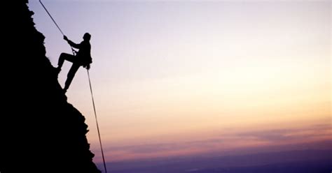 mountain climbers retrieve ropes