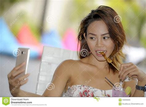 Happy Asian Girl In Dress Having Brunch Or Lunch At Holiday Resort