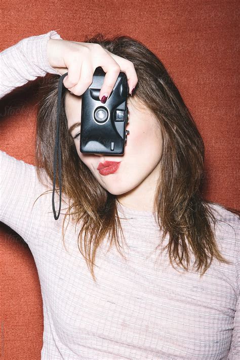 Close Up Of Young Woman With Red Lips Holding Film Camera By Stocksy