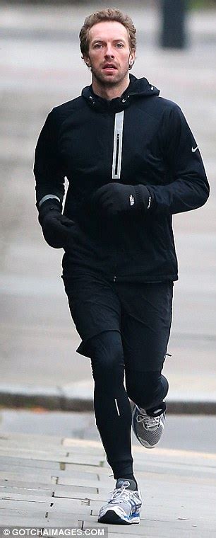 chris martin covers up in all black workout gear as he
