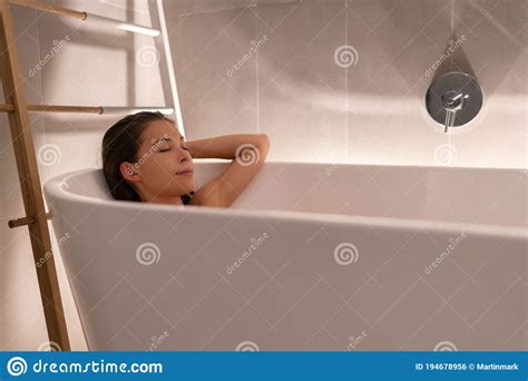 Luxury Bathtub Asian Woman Relaxing In Home Spa Taking A Bath Shower