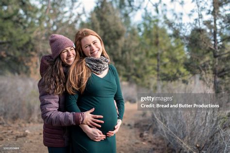 Happy Lesbian Couple Outdoors Sharing Moment Of Pregnancy Joy Together