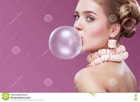 Beautiful Blonde Woman Blowing Pink Bubble Gum Fashion Portrait Stock