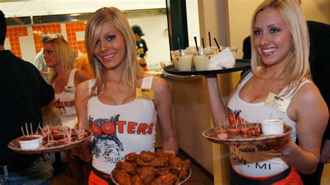 gray suits and orange hotpants welcome to new hooters nyc