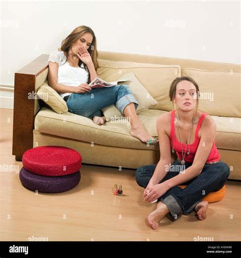 Pictures In A Living Room Of Two Young Girls Sitting On A Couch Stock