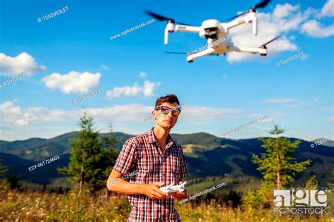 man operating copter controller  mountains drone remote control stock photo picture