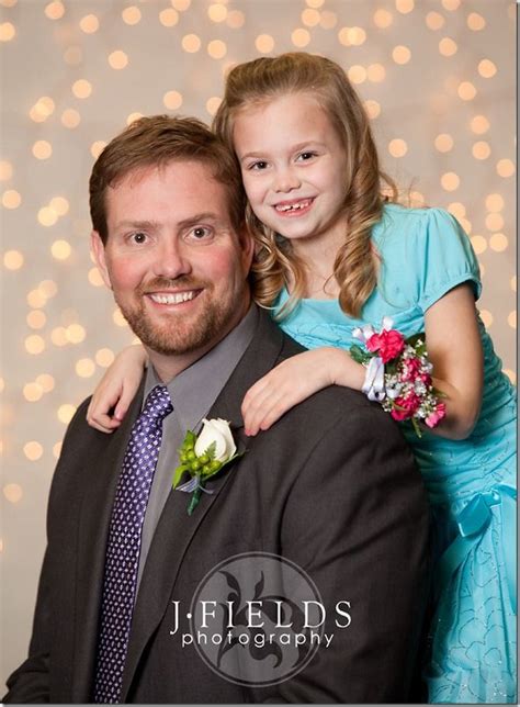 white lights in front of a white background with a shallow aperture father daughter poses