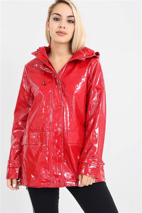 blond model in red pvc three quarter length raincoat