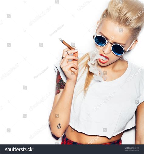 Sexy Woman In Sunglasses And White T Shirt Blowing Smoke