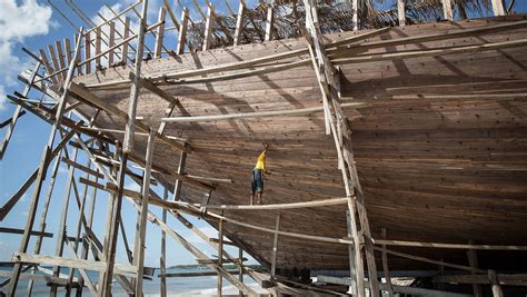 indonesian craftsmen build traditional sailing ship