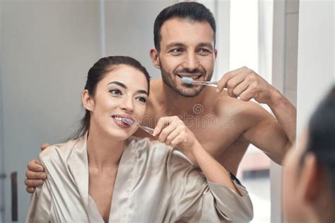 cute married couple doing morning procedures in bathroom