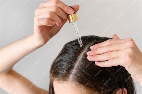 Premium Photo Close Up Woman Applying Serum For Hair
