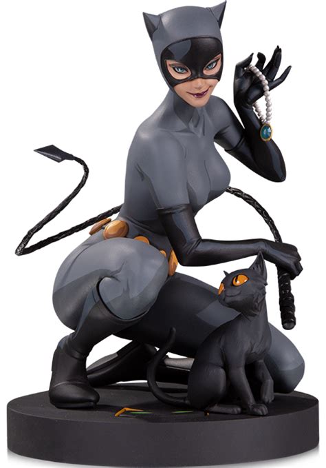 A Statue Of A Catwoman Holding A Key To Her Chest With Two Cats On It