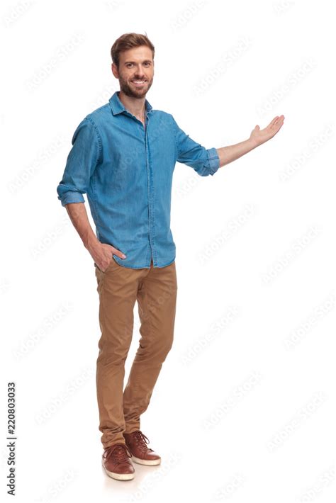 full body picture   young casual man presenting stock photo adobe stock