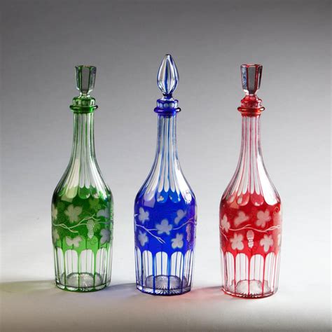 A Set Of Three Coloured Glass Bottles Bada
