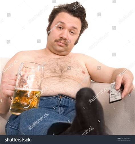 Overweight Man Sitting On The Couch With A Beer Glass