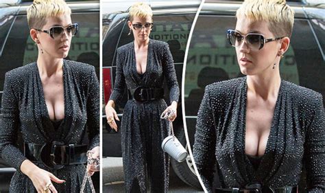 katy perry flashes extreme cleavage as assets spill out of dangerously low cut jumpsuit