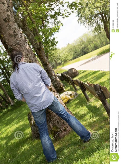 Back View Of A Peeing Man In The Nature Stock Image