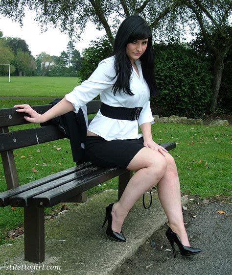 clothed model nicola poses on a park bench to show off her sexy legs