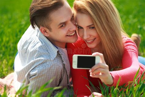 Couples With Phone Taking Selfie Self Portrait At The Park Stock Image