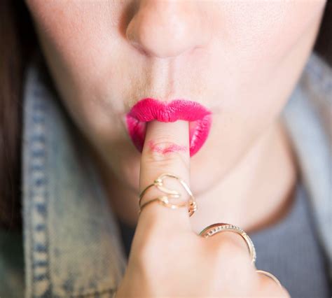keep lipstick off your teeth by sticking your clean pointer finger in
