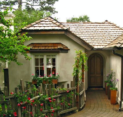 small house  flowers growing   front door  side windows