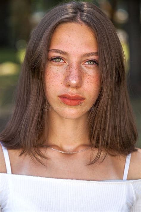 Young Beautiful Brown Haired Girl With Freckles On Her Face Stock Image