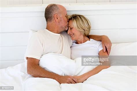 Mature Couple Kissing Bed Bildbanksfoton Och Bilder Getty Images