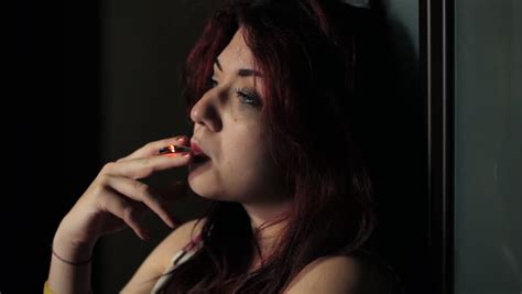 a drugged woman is smoking a joint to forget her life addict drug stock footage video