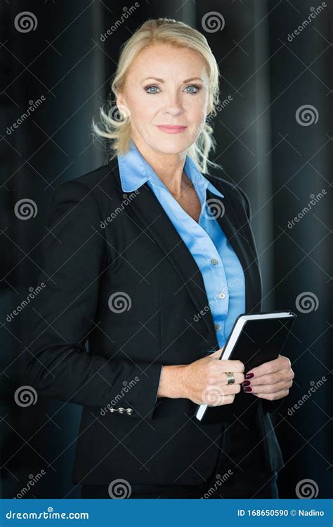 Portrait Of A Mature Serious Businesswoman Looking At The Camera Stock