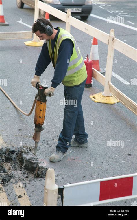 workman digging road stock photo alamy