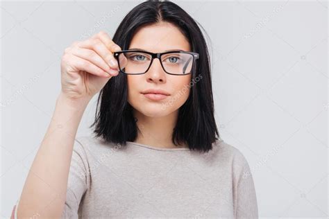 close up photo of pretty smart girl touching her glasses