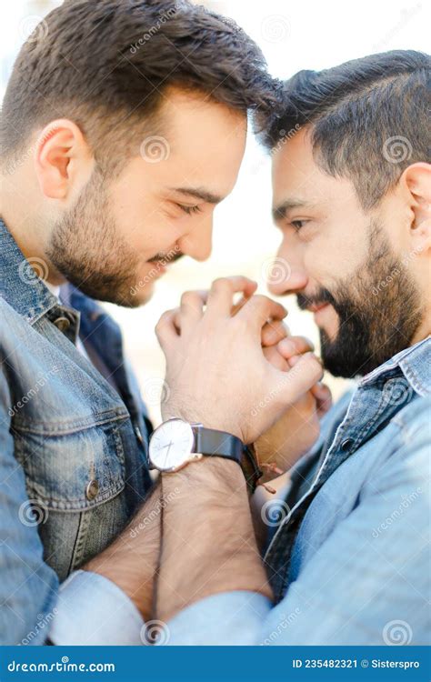 Portrait Of Young Gays Holding Hands And Wearing Jeans Shirts Stock