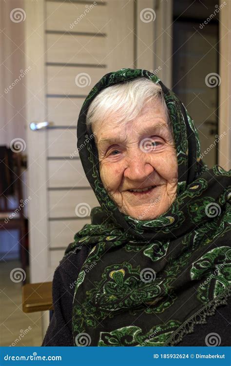 Portrait Of An Old Russian Happy Woman With A Scarf On Her Head Stock