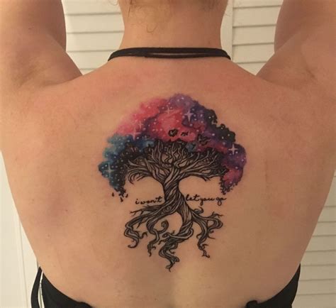 A Womans Back With A Tree Tattoo On Her Left Shoulder And Stars In The