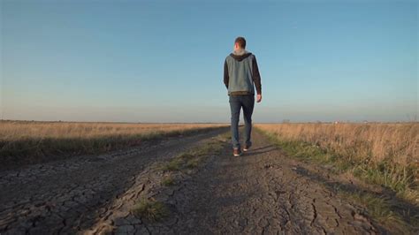 young man walking  rural road  unique stock footage sbv