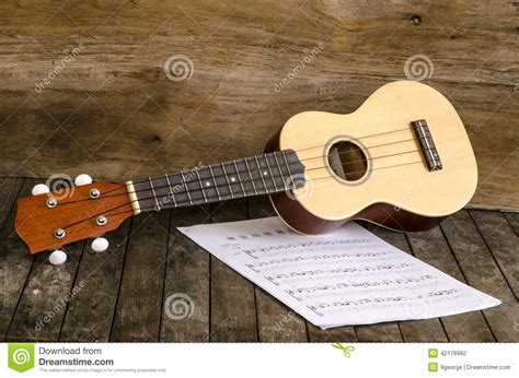 ukulele  paper chordschart document  wooden background stock photo image  craft