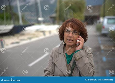 Portrait Of Beautiful Tanned Mature Brunette With Eyeglasses Stock
