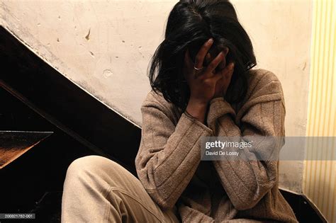 Woman Sitting On Steps Covering Face Photo Getty Images