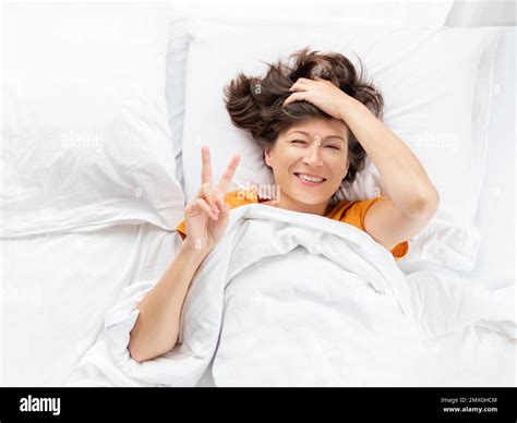 Top View On Sleepy Woman Showing Victory Gesture In Bed Woman
