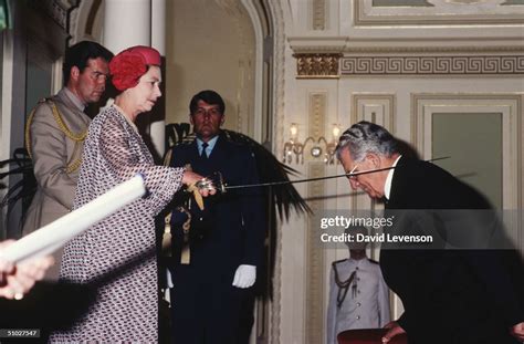 Queen Elizabeth Ii Knighting Sir Jack Leggo At An Investiture In