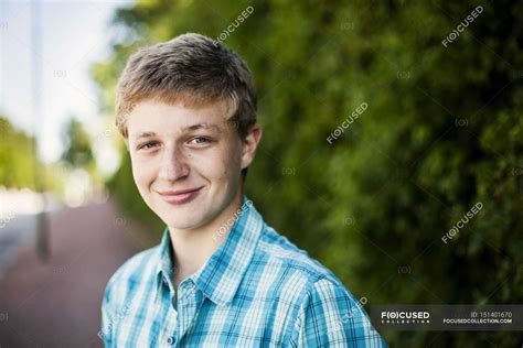 teenage boy smiling outdoors teenager stock photo