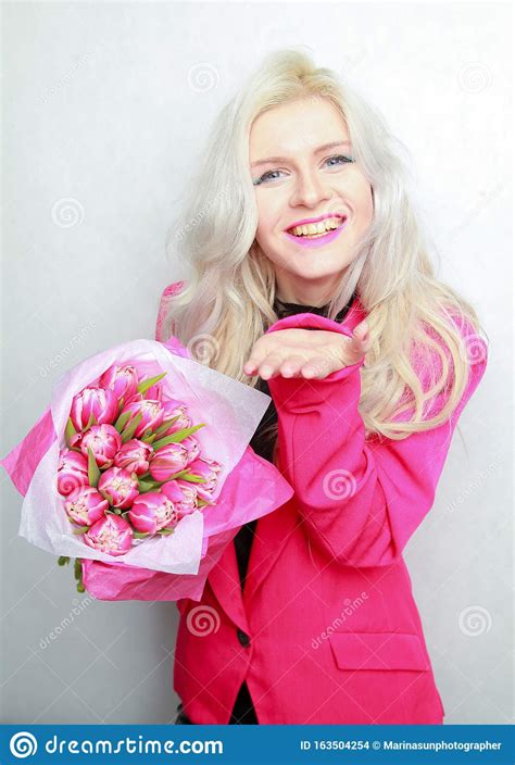 tender pretty blonde slim teen girl with pink flowers