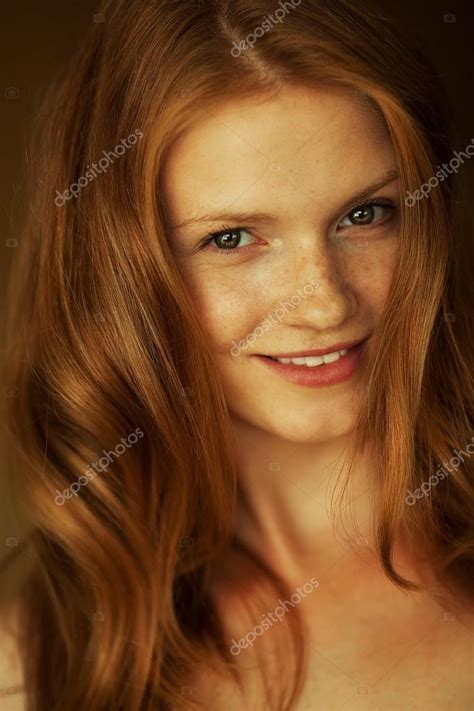 portrait of a smiling beautiful red haired ginger girl with fu