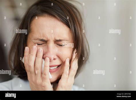 Close Up Portrait Of Disheveled Adult Woman Crying Hysterically With