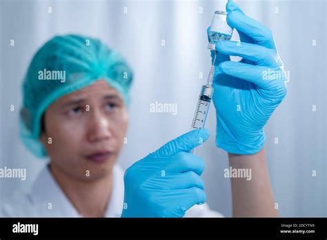 Doctor S Hands Fill Syringe With Medicine Vial On Hands Of A Nurse