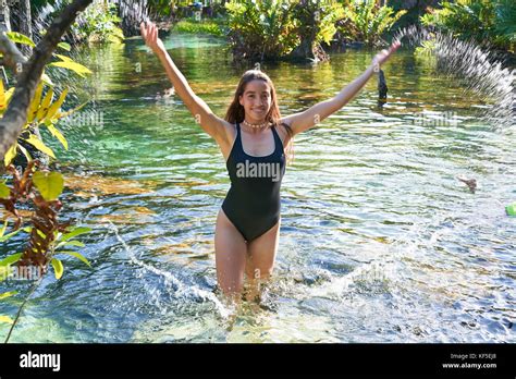 Beautiful Teen Girl In Cenote Of Riviera Maya Splashing Water With