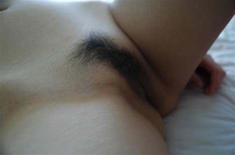 asian babe posing naked and demonstrating her hairy cunt in close up