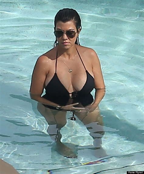 kourtney kardashian shows her curves in plunging one piece photos